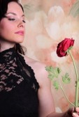 3322075-beautiful-young-woman-holding-a-rose-studio-photo
